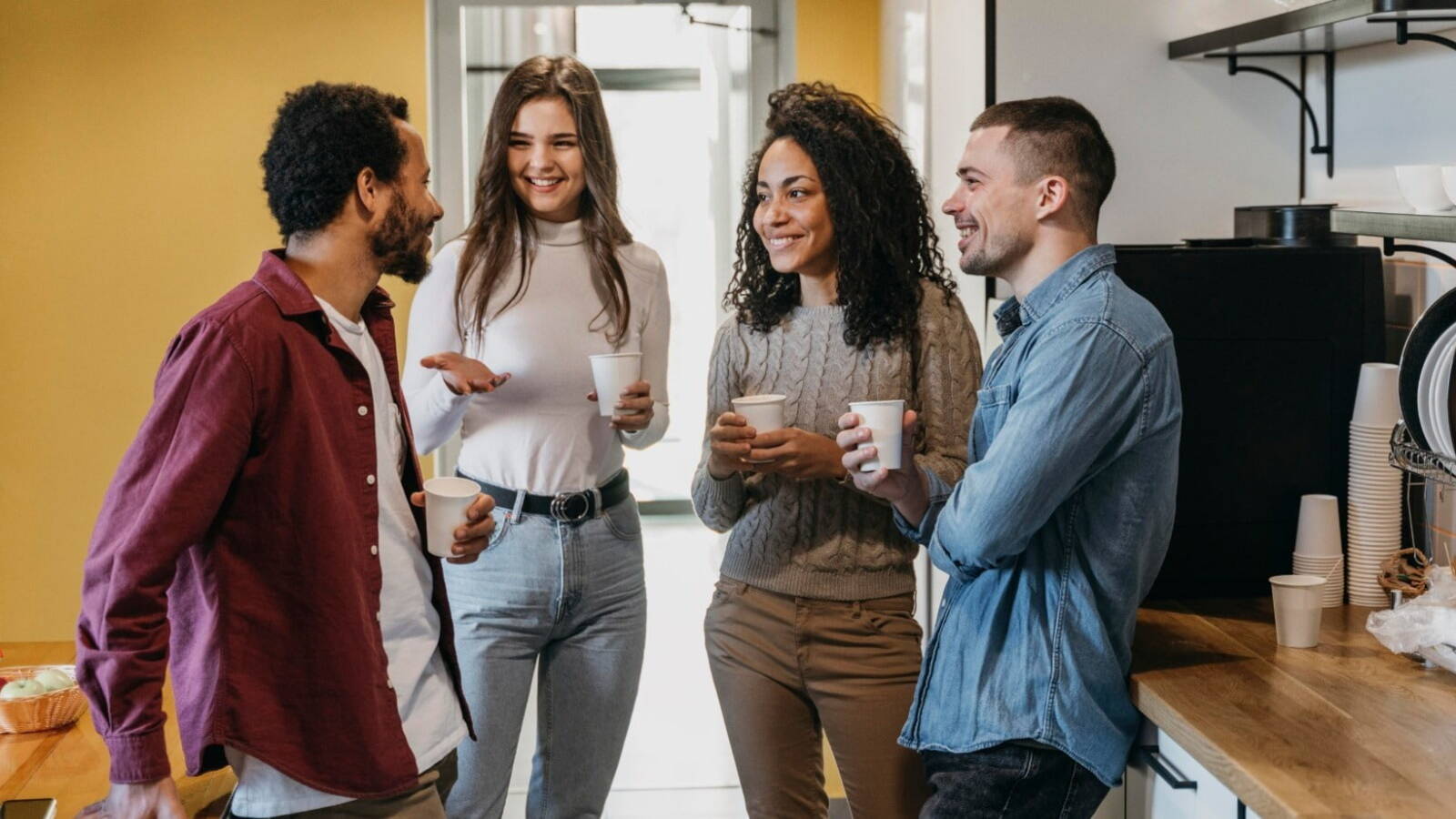 4 young people speaking english at work